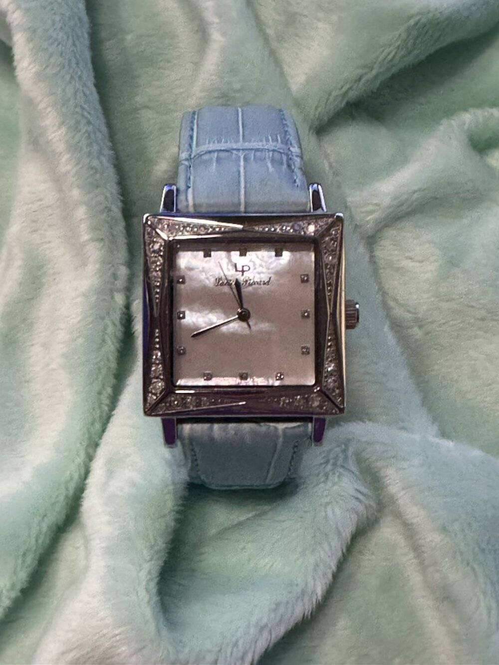 Lucien Piccard Watch with a seafoam leather band. Silver with faux diamonds.